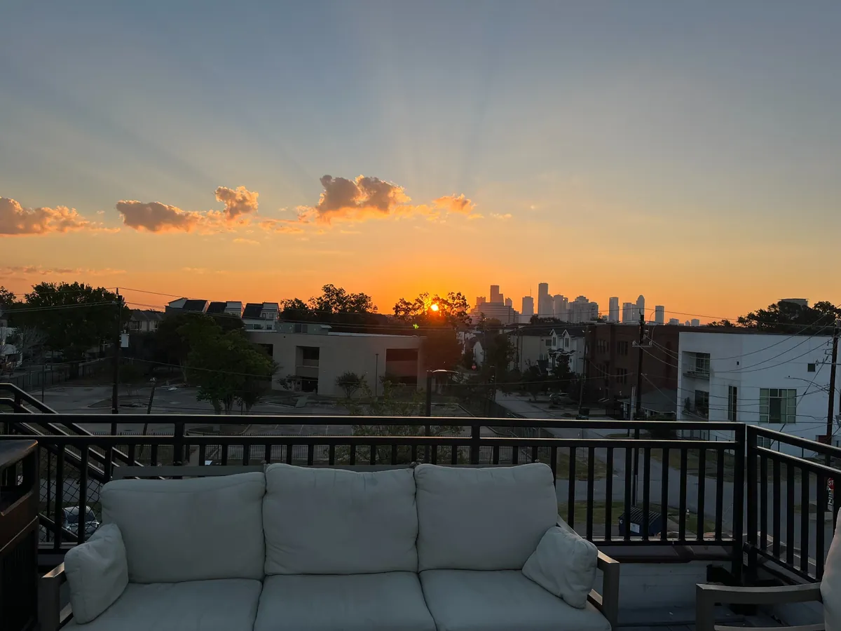 Sunset view of Houston skyline from a rooftop terrace